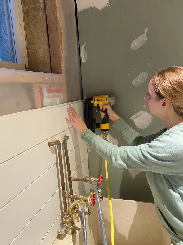 Using a nail gun to install shiplap