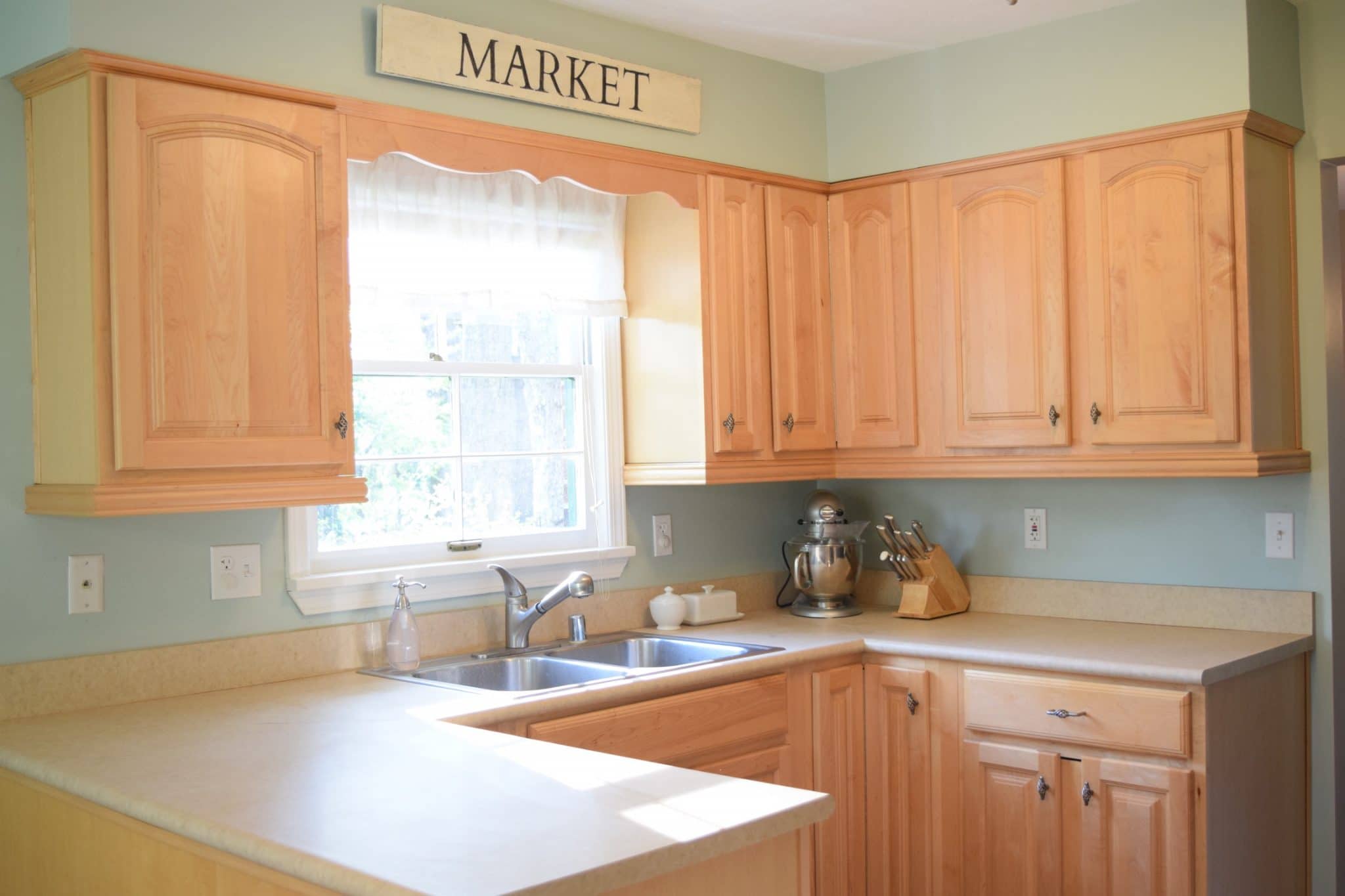 blue kitchen wall with honey oak cabinet