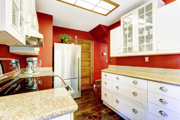 red kitchen walls with white cabinet